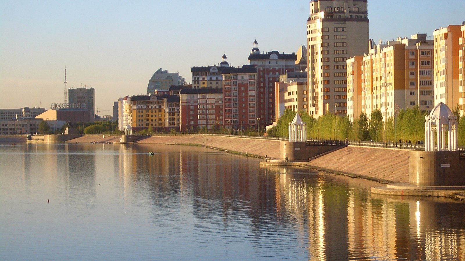 Modern apartment and office towers along a river embankment